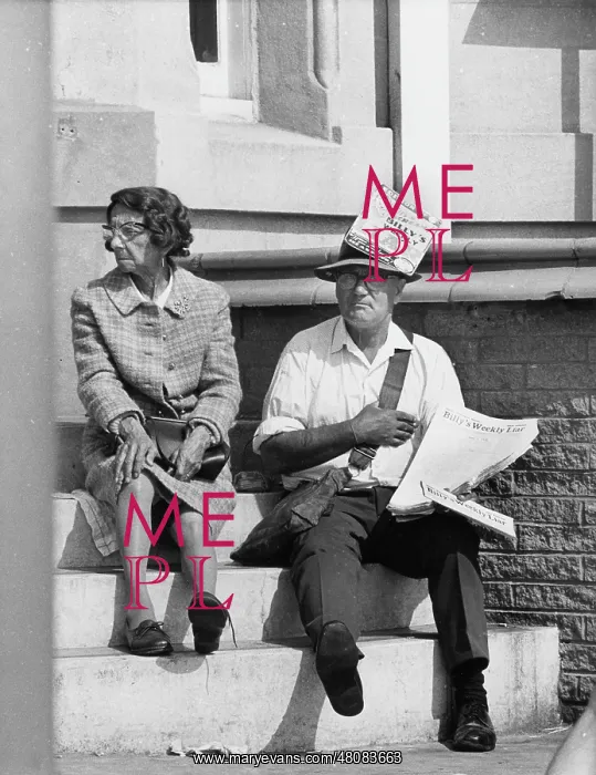 : Middle-aged man and woman sitting on steps, Blackpool : Middle-aged man and woman sitting on steps, Blackpool