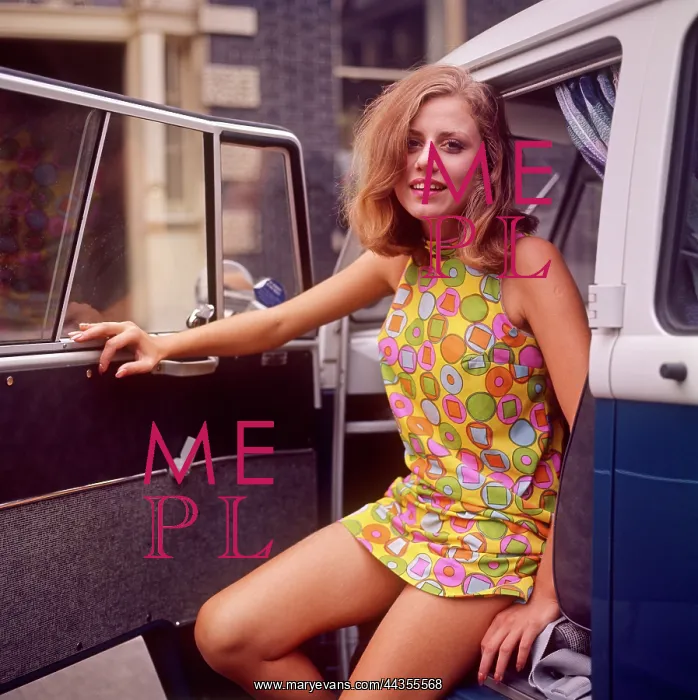 : Model in colourful mini dress with camper van : Model in colourful mini dress with camper van