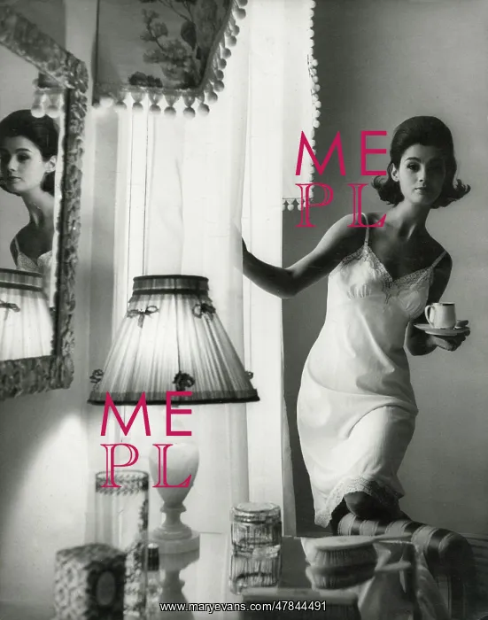 : Model in fitted white nightdress holding a cup of tea : Model in fitted white nightdress holding a cup of tea
