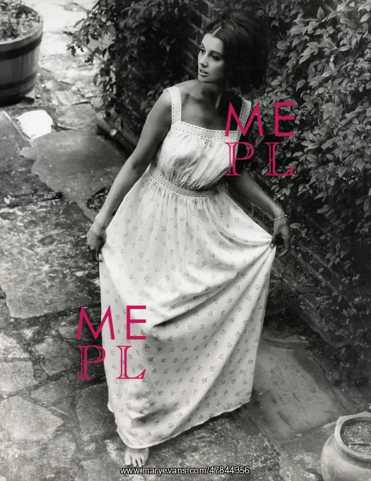: Model in a garden setting wearing a light summer dress : Model in a garden setting wearing a light summer dress