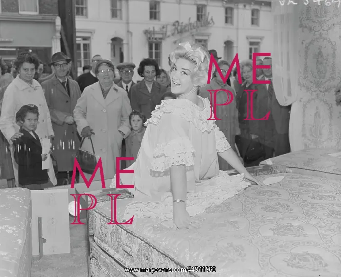 : Model poses on bed in shop window, Bexley : Model poses on bed in shop window, Bexley