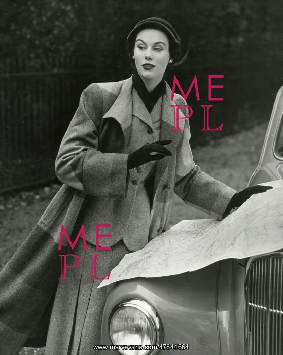: Model in striped long woollen coat reading a map : Model in striped long woollen coat reading a map