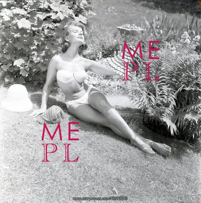 : Model sunbathing in a white bikini : Model sunbathing in a white bikini