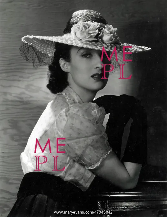 : Model in wide-brimmed straw hat and pale blouse : Model in wide-brimmed straw hat and pale blouse