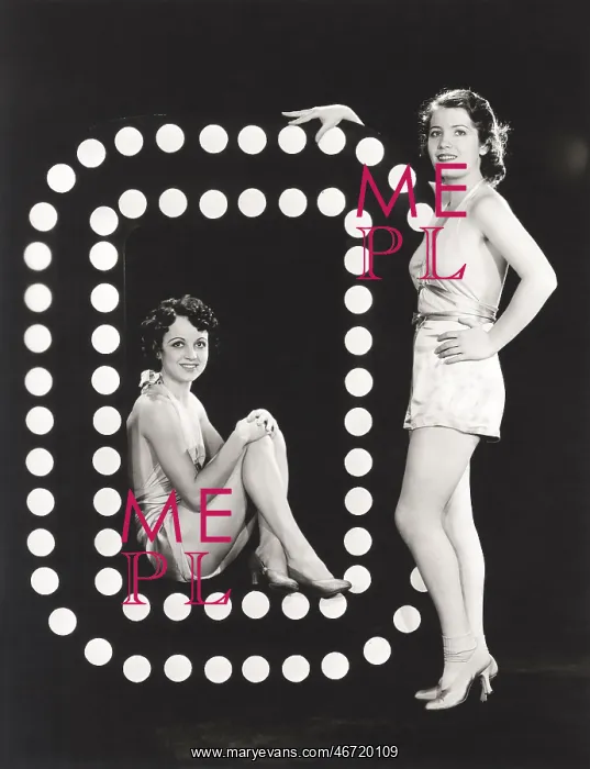 : Two models posing by large letter O : Two models posing by large letter O