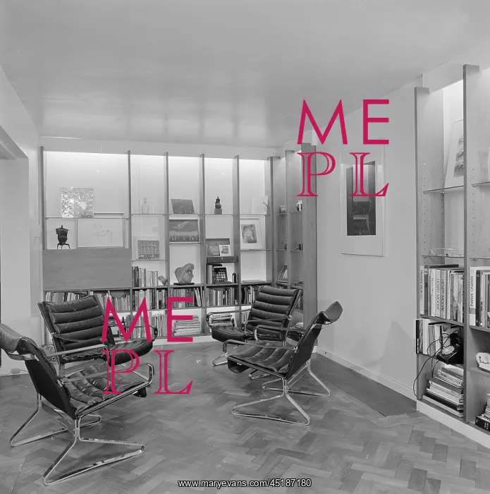 : A modern interior with integral shelving and leather arm chairs : A modern interior with integral shelving and leather arm chairs
