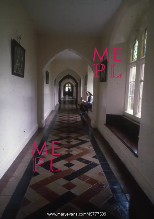  : Monastic life - nun sits reading in a tiled corridor