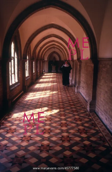 : Monastic life - nun walking along a tiled corridor : Monastic life - nun walking along a tiled corridor
