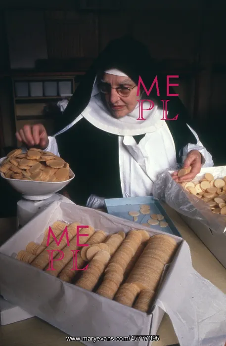 : Monastic life - nun weighing and packing biscuits : Monastic life - nun weighing and packing biscuits