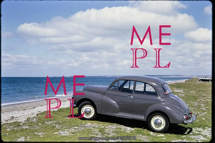: A Morris Minor parking on grass overlooking Traeth Llanddwyn : A Morris Minor parking on grass overlooking Traeth Llanddwyn