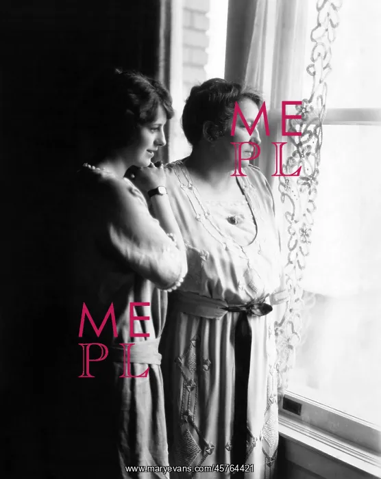 : Mother and daughter gazing out window : Mother and daughter gazing out window