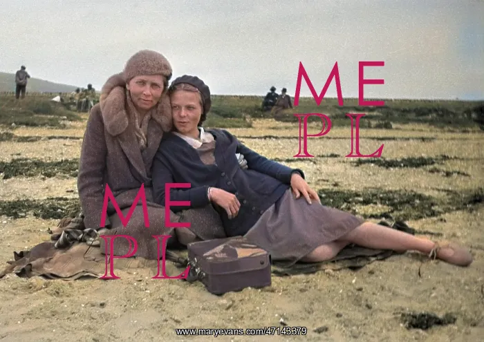  : Mother and daughter sitting on a beach