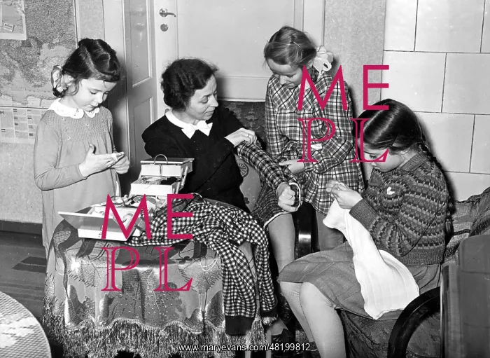 : Mother with her daughters doing handwork, 1941 : Mother with her daughters doing handwork, 1941
