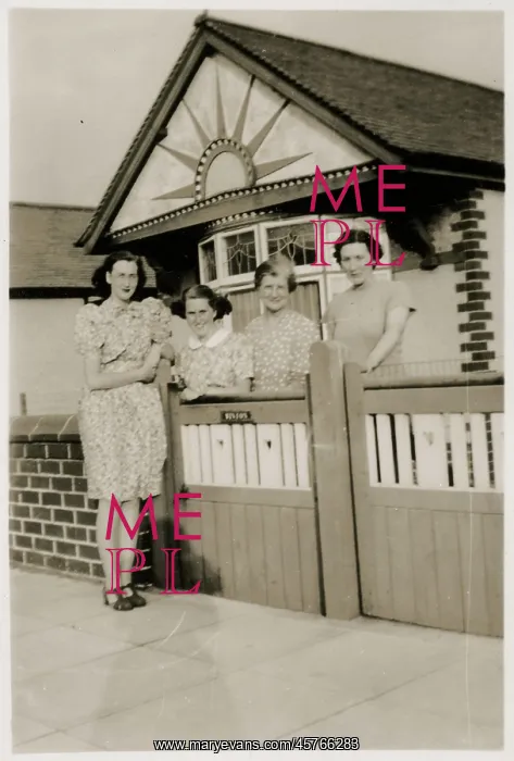 : Mother and daughters by the gate of a lovely bungalow : Mother and daughters by the gate of a lovely bungalow