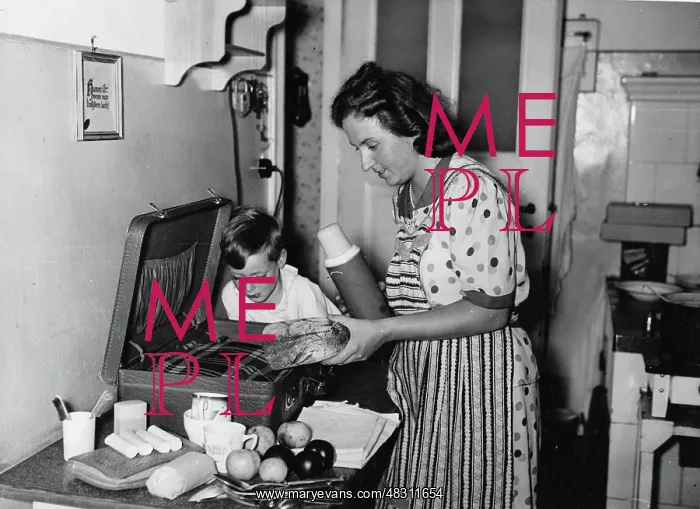 : Mother packing an emergency baggage for air raid, 1943 : Mother packing an emergency baggage for air raid, 1943