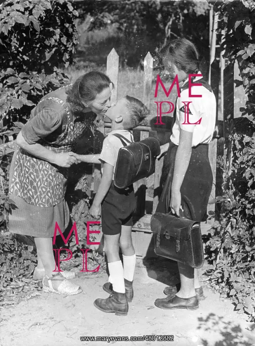 : A mother says goodbye to her children as they go to school : A mother says goodbye to her children as they go to school