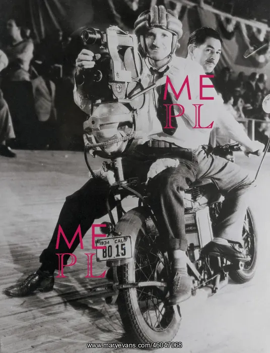 : A motorcycle race is being filmed : A motorcycle race is being filmed