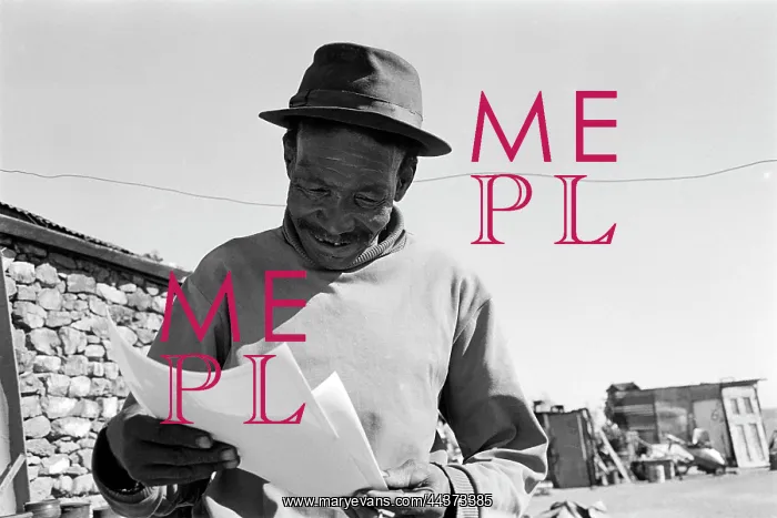 : Mr Modikwane Molefe looks at photographs of himself : Mr Modikwane Molefe looks at photographs of himself