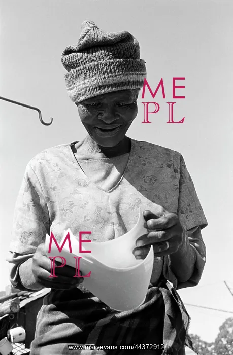 : Mrs Molefe looks at photographs of herself. Mr and : Mrs Molefe looks at photographs of herself. Mr and