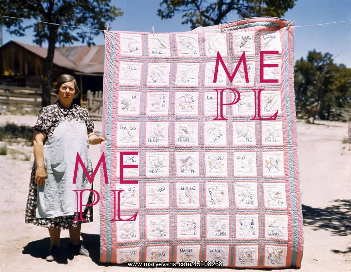 : Mrs. Bill Stagg with state quilt that she ? : Mrs. Bill Stagg with state quilt that she ?