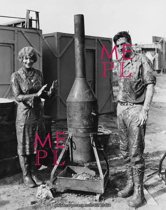 : Mud covered couple with portable stove : Mud covered couple with portable stove
