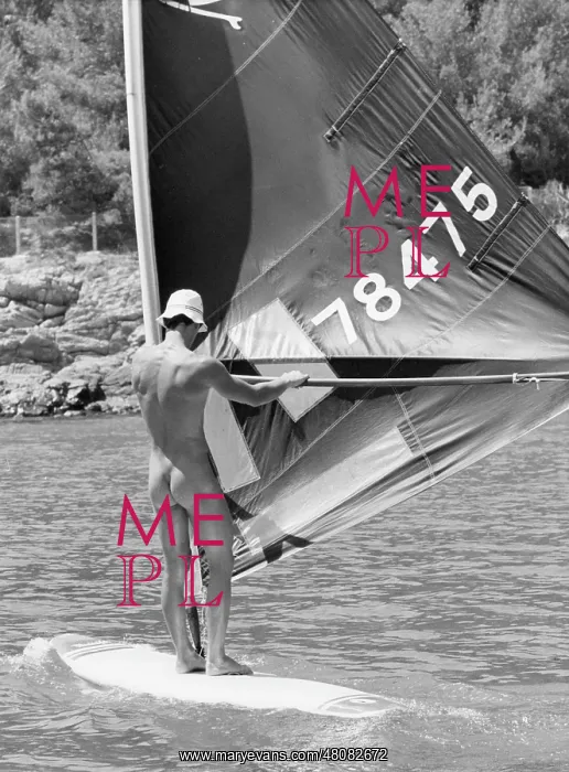 : Naked holidaymaker on a windsurfer : Naked holidaymaker on a windsurfer