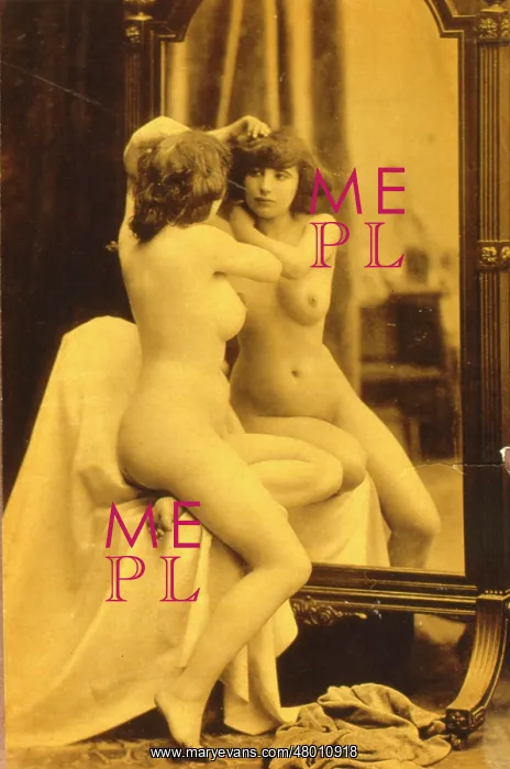 : Naked woman looking at her reflection in a mirror : Naked woman looking at her reflection in a mirror