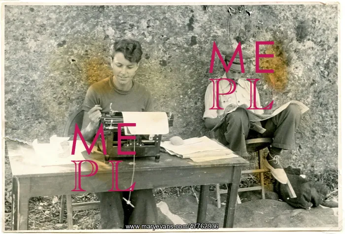 : Nan Green with typewriter, next to man reading newspaper, Ebro : Nan Green with typewriter, next to man reading newspaper, Ebro
