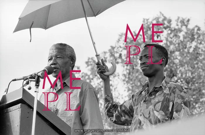 : Nelson Mandela, standing beneath an umbrella : Nelson Mandela, standing beneath an umbrella