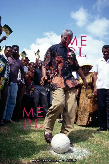 : Nelson Mandela, watched by local residents and : Nelson Mandela, watched by local residents and