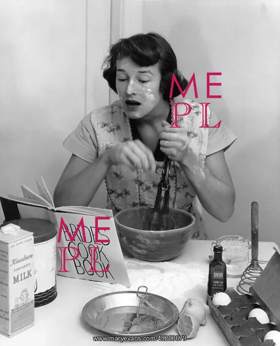 : New bride baking while reading how to do it from book : New bride baking while reading how to do it from book