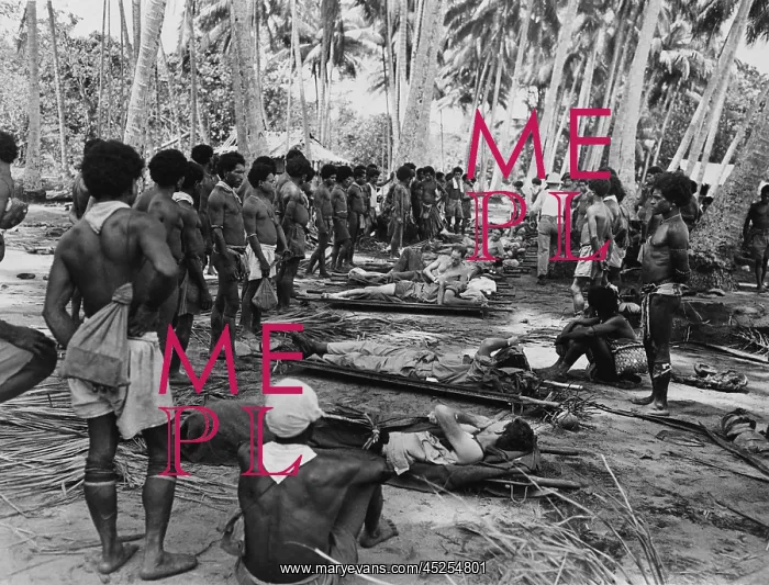 : New Guinean native stretcher bearers pause in : New Guinean native stretcher bearers pause in