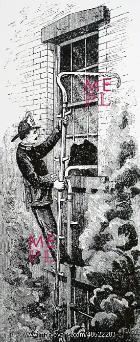 : A New York fireman using an escape ladder to reach : A New York fireman using an escape ladder to reach
