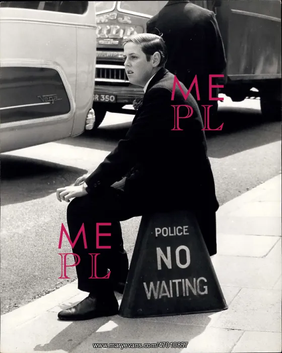: Nicholas Soames sits on No Waiting sign, Eton : Nicholas Soames sits on No Waiting sign, Eton