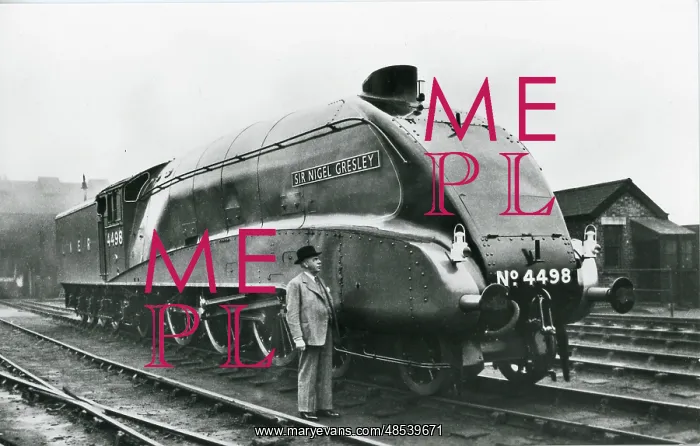  : Nigel Gresley standing alongside his A4 class steam engine