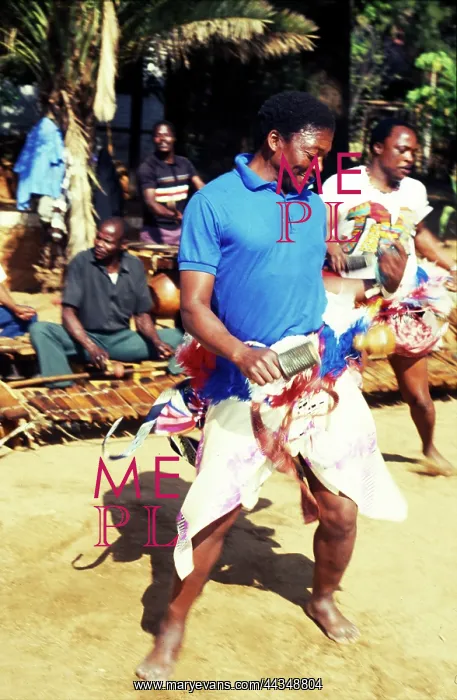 : Njele rattle player dancing in front of timbila orchestra : Njele rattle player dancing in front of timbila orchestra