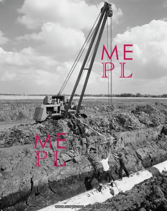 : Norfolk. A pipelayer with a side boom and a team of workers laying a section : Norfolk. A pipelayer with a side boom and a team of workers laying a section