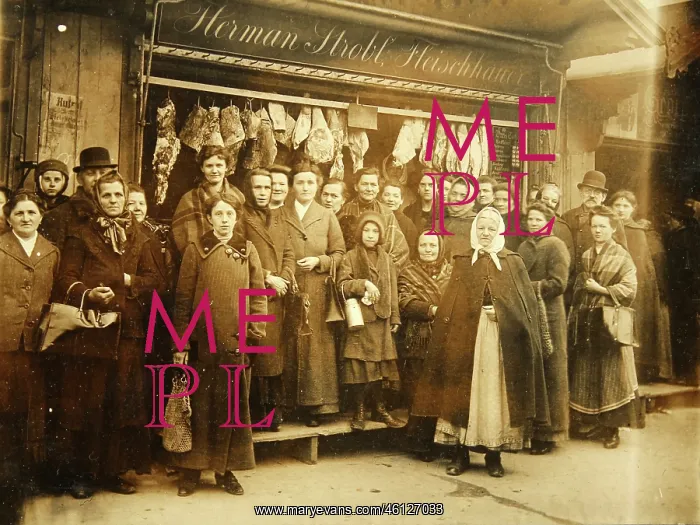 : A number of people in front of the butcher : A number of people in front of the butcher