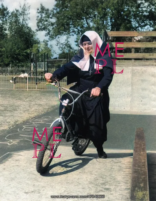  : Nun on a bicycle in a playground