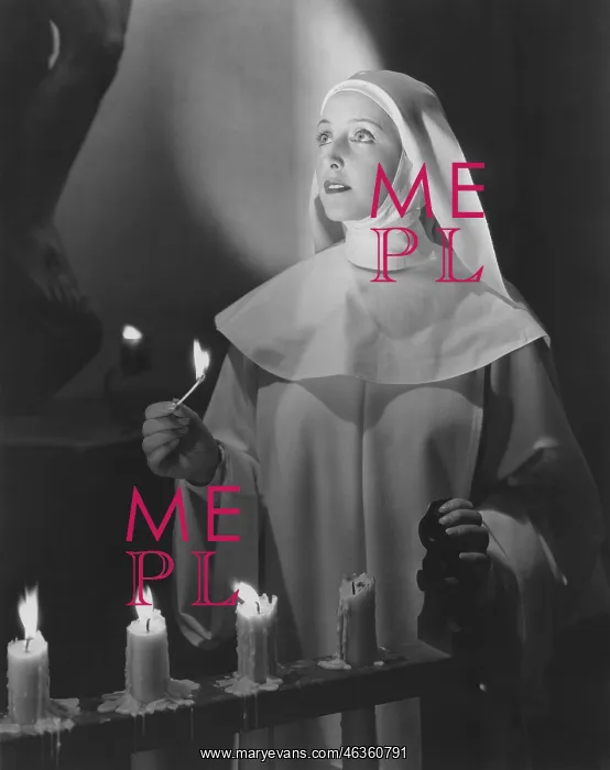 : Nun lighting candles in church : Nun lighting candles in church