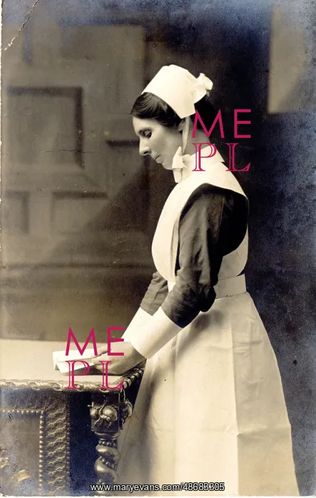: Nurse Standing at Table with Book : Nurse Standing at Table with Book
