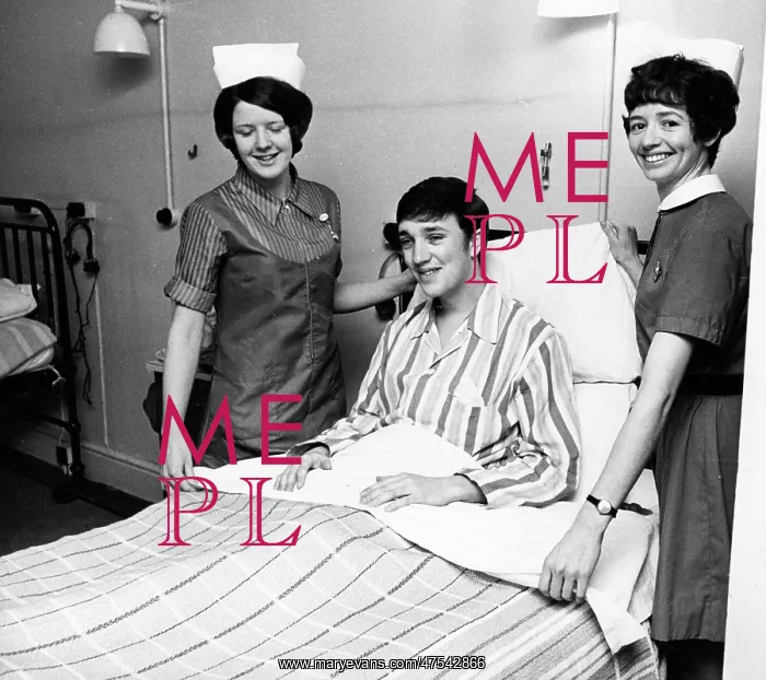 : Two nurses with patient in hospital ward : Two nurses with patient in hospital ward