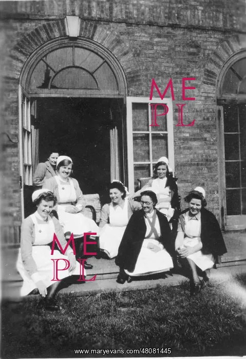: Six nurses and woman on steps : Six nurses and woman on steps