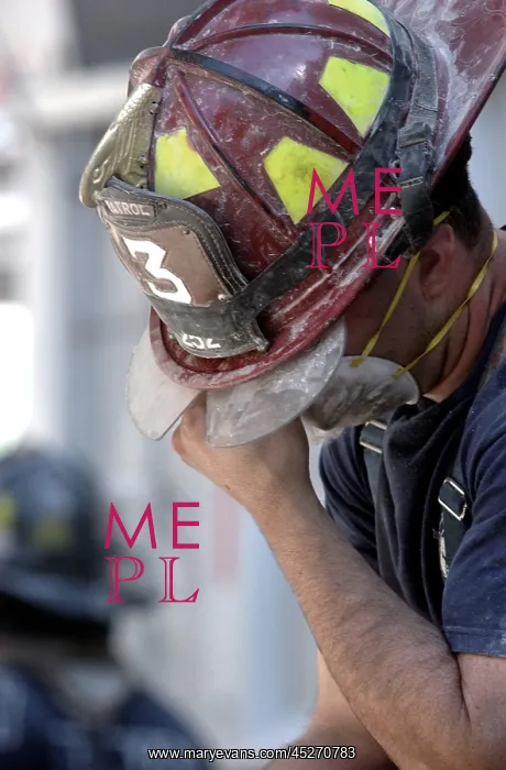 : NYC Fireman takes a break during the rescue operations : NYC Fireman takes a break during the rescue operations
