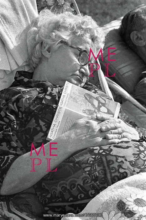 : Old lady asleep with paperback book : Old lady asleep with paperback book