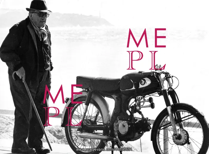 : Old man standing next to a motorcycle near a beach : Old man standing next to a motorcycle near a beach