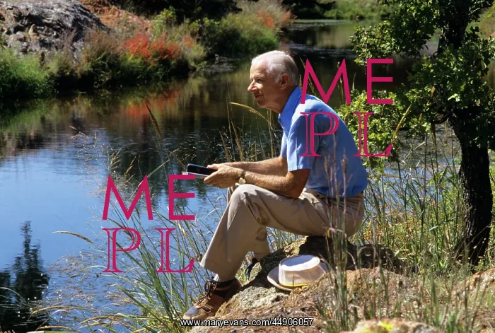  : Older man sitting by the stream holding bibles