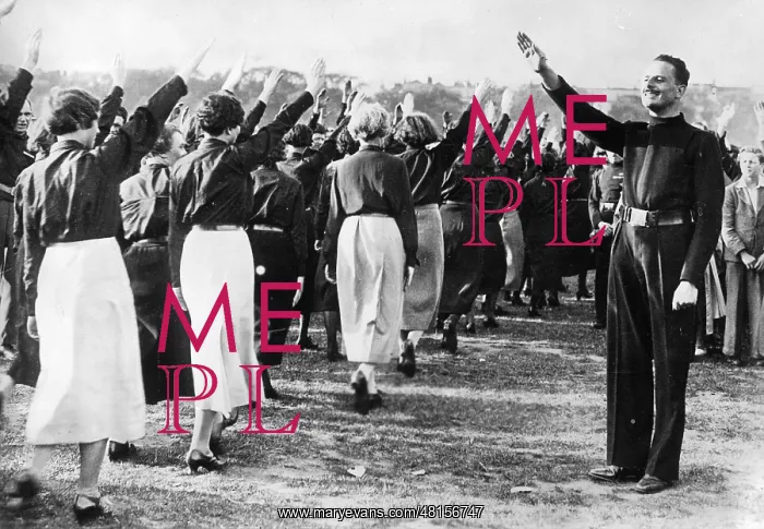 : Oswald Mosley greets marching by members of the British Unio : Oswald Mosley greets marching by members of the British Unio
