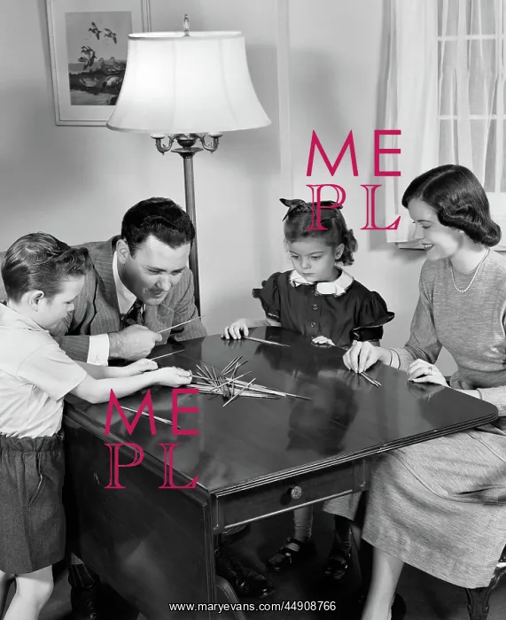 : Parents playing pick up sticks game with young : Parents playing pick up sticks game with young