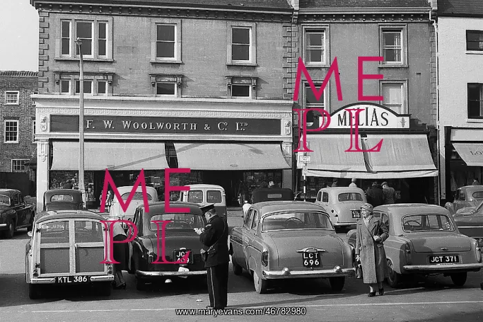 : A parking attendant writing out ticket, Middlesex : A parking attendant writing out ticket, Middlesex
